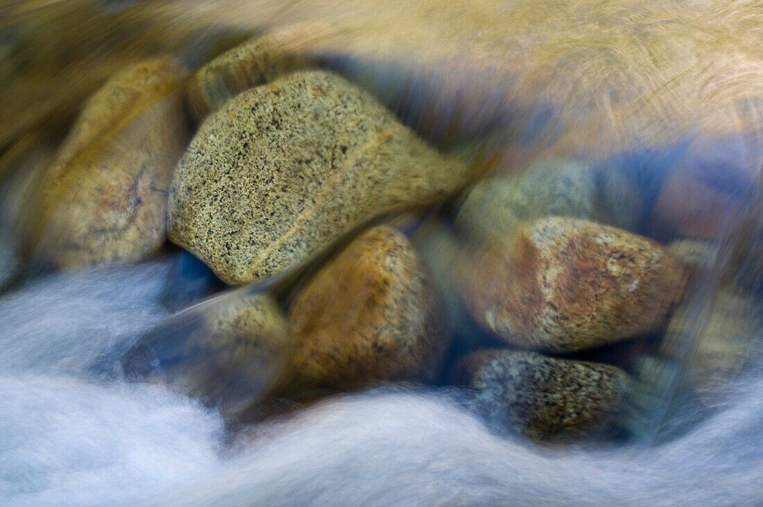 Granite rocksunder flowing water in the Merced River, Yosmite Valley, Yosemite National Park, California