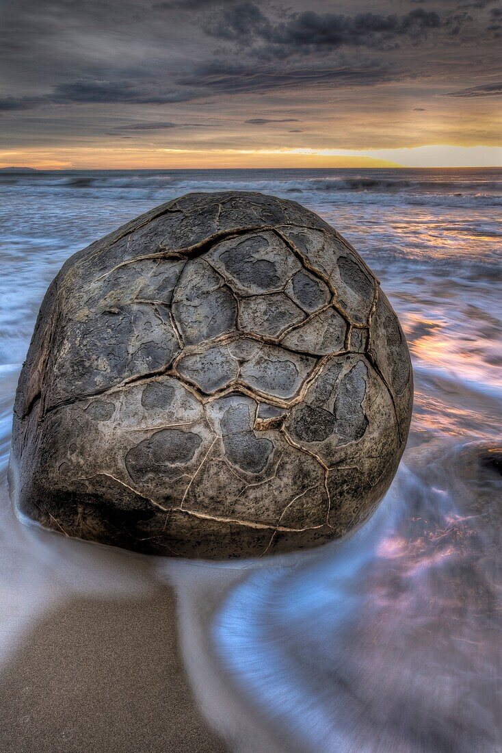 Moeraki boulders at dawn as SW front passes overhead, near Oamaru, Otago