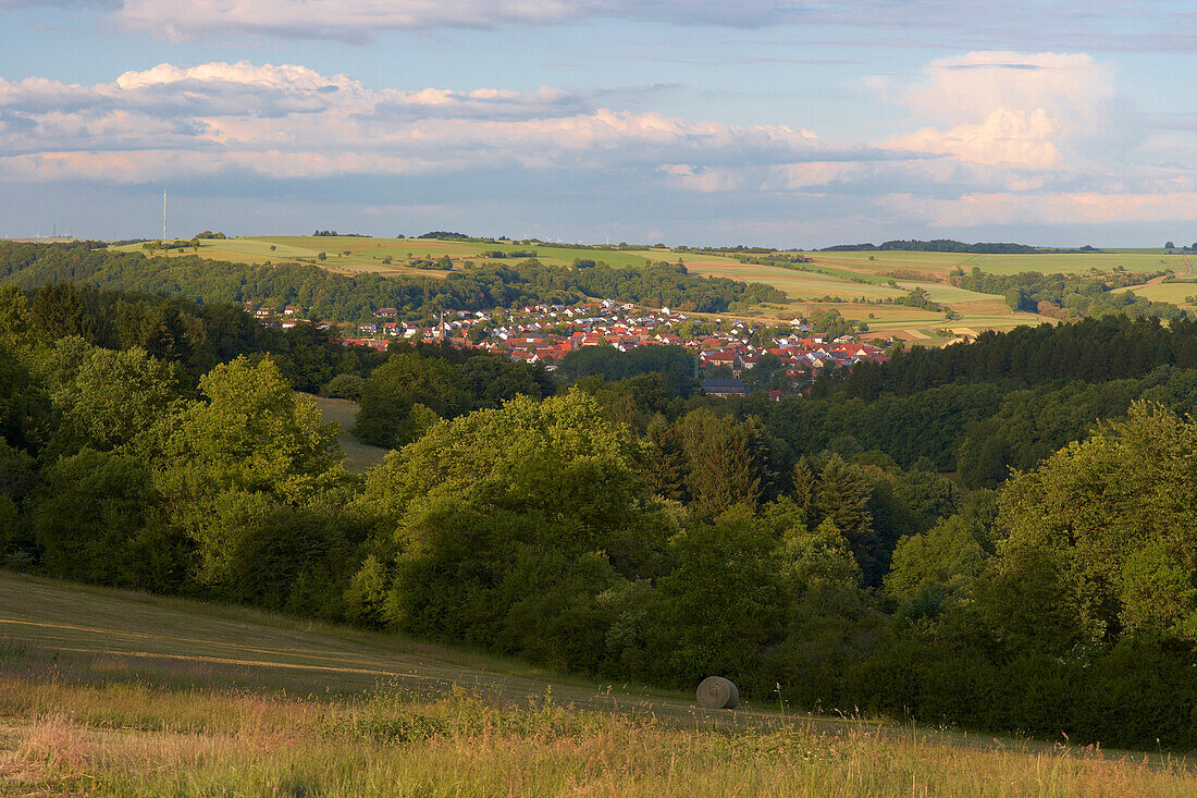 View over forest onto the town of Blieskastel at dusk, Bliesgau, Saarland, Germany, Europe