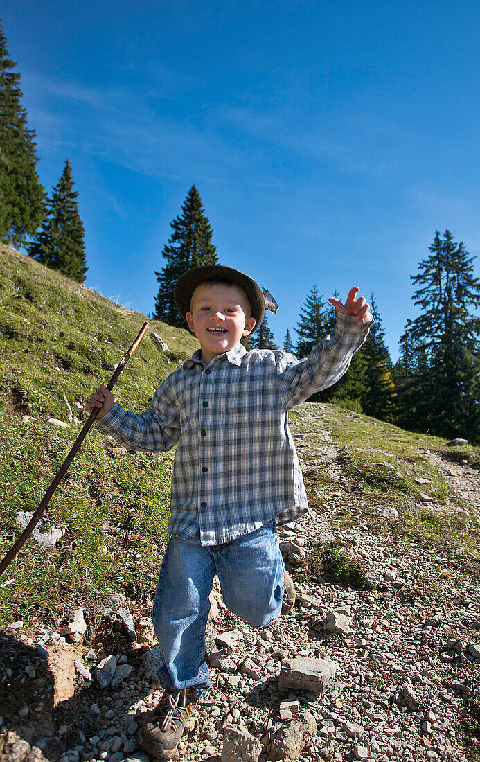 Boy running downhill, Hofbauern-Alm, Kampenwand, Chiemgau, Upper Bavaria, Germany