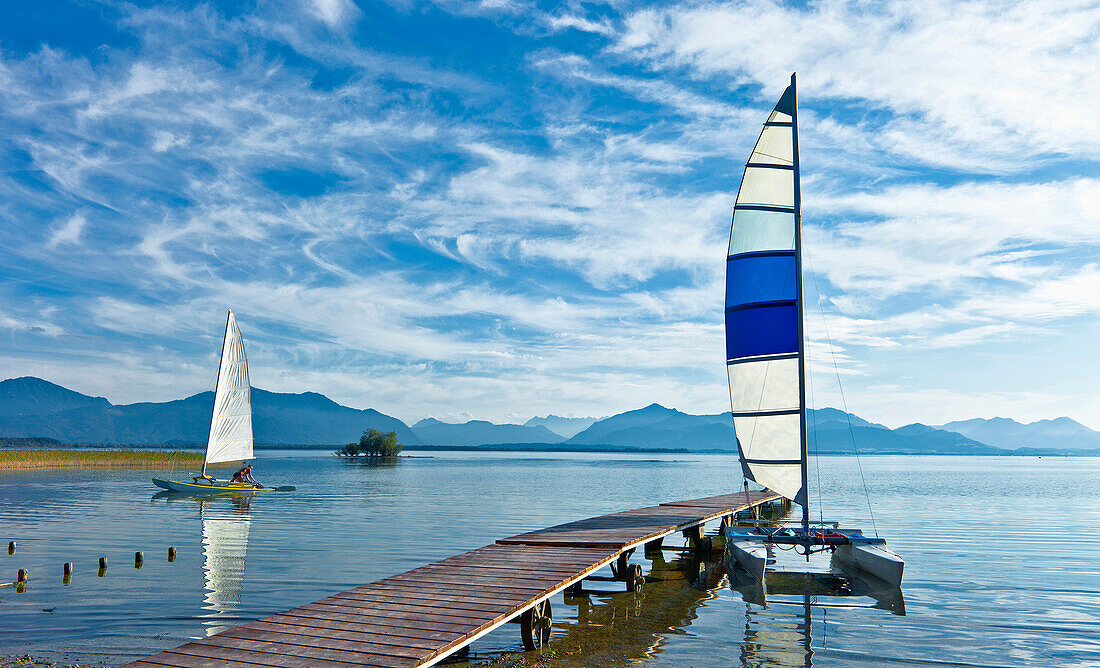 Catamaran beside jetty at lake Chiemsee, Schuetzing, Chieming, Chiemgau, Upper Bavaria, Germany