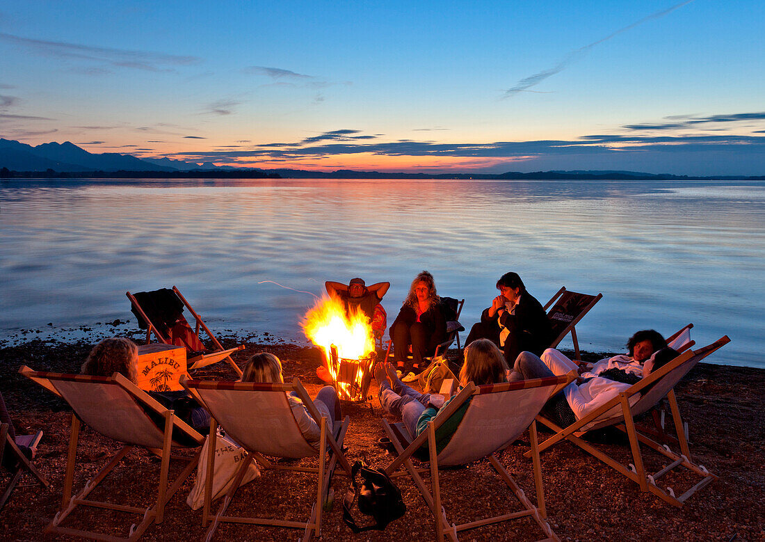 Group around a campfire, lido Uebersee, lake Chiemsee, Chiemgau, Upper Bavaria, Germany