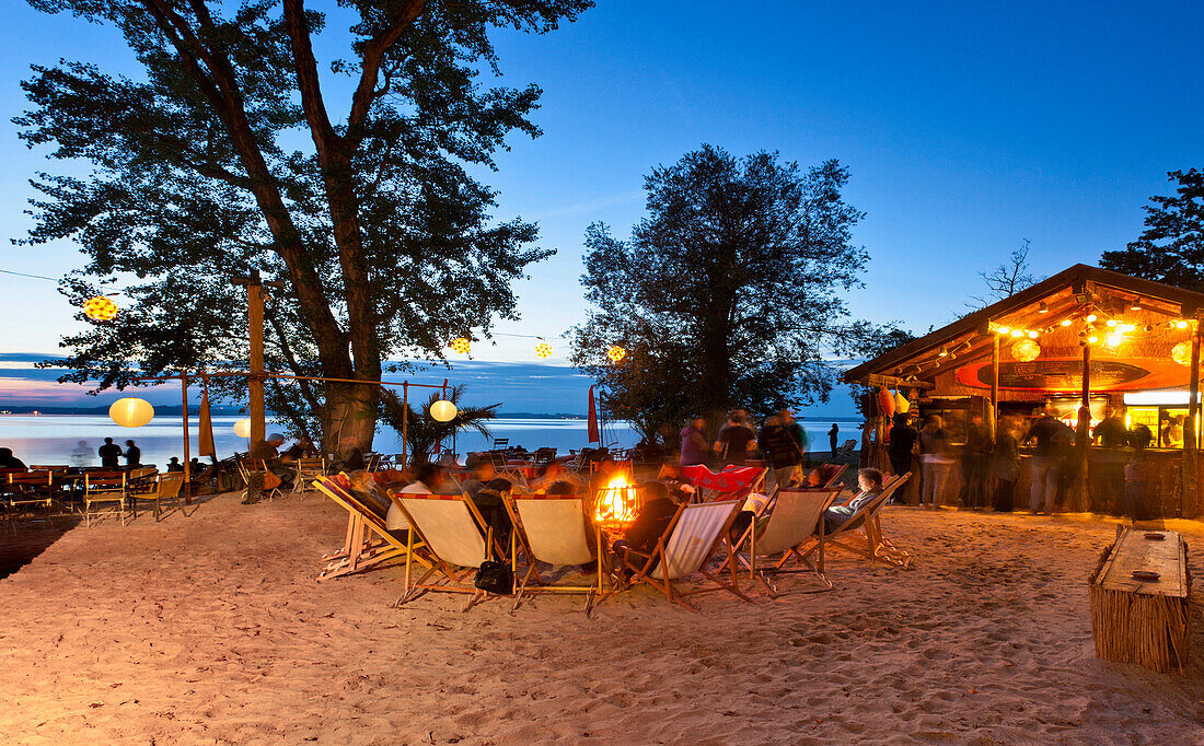 Guests in a beachbar in the evening, lido, Uebersee, lake Chiemsee, Chiemgau, Upper Bavaria, Germany