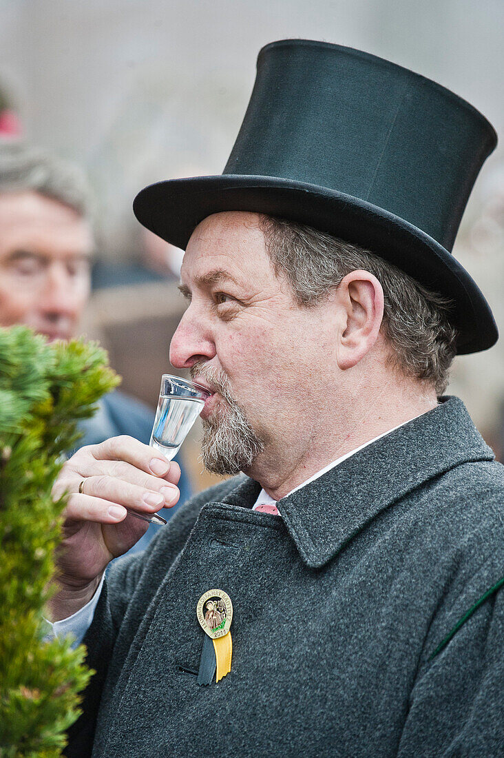 Man drinking schnaps, Leonhardi Procession, Bad Toelz, Upper Bavaria, Bavaria, Germany