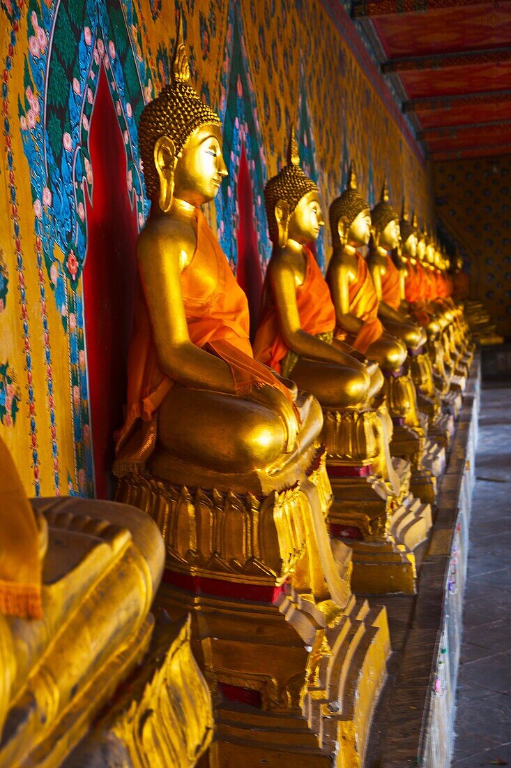 The long line of golden Buddhas in Wat Arun, The Temple of the Dawn  Bangkok, Thailand, Southeast Asia, Asia