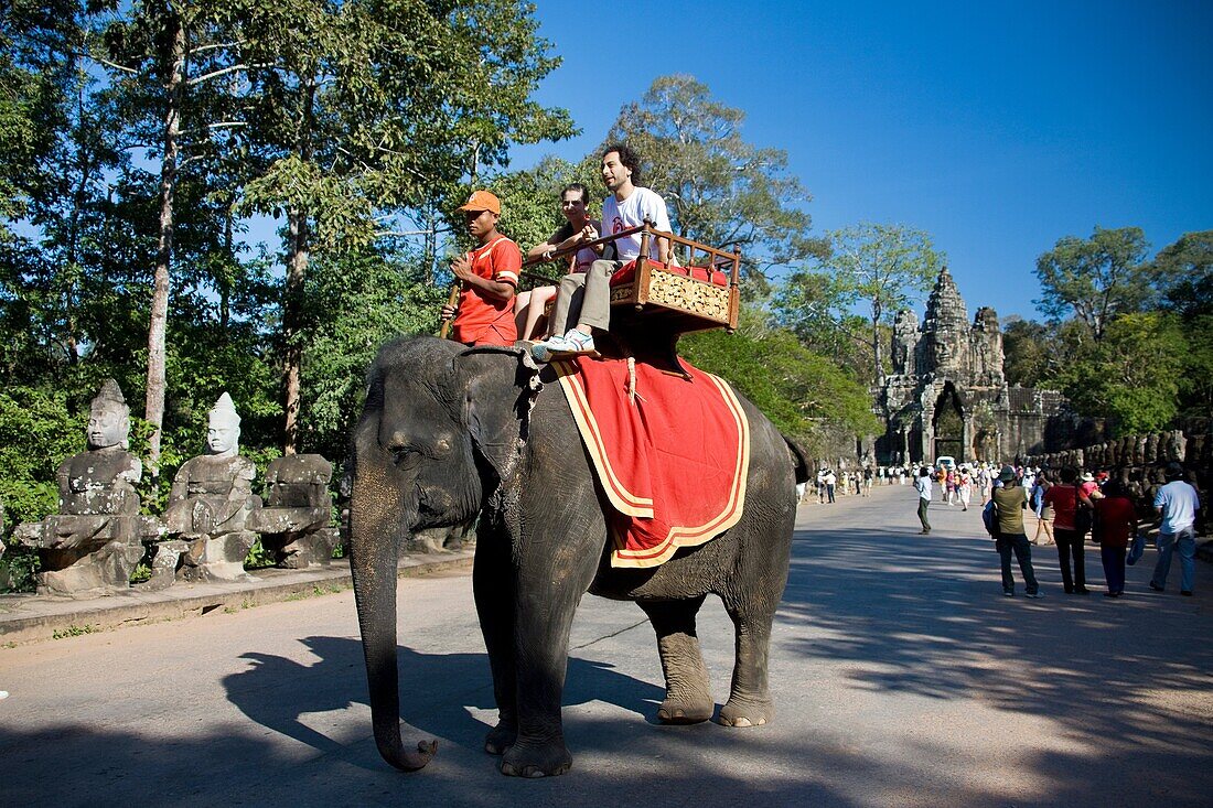 Cambodia-No  2009 Siem Reap City Angkor Temples Angkor Thom Temple South Gate Tourists on elephant.