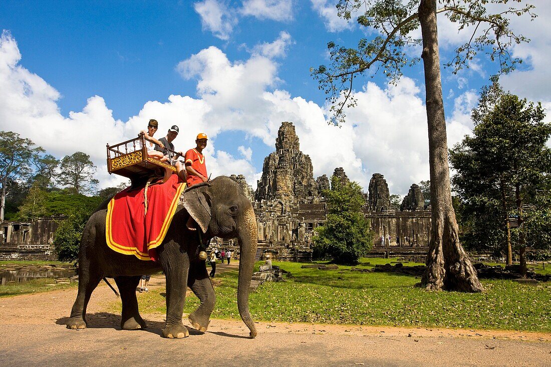 Cambodia-No  2009 Siem Reap City Angkor Temples W H  Bayon Temple within Angkor Thom Tourists on elephants.