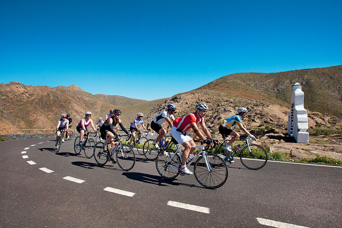 Cyclists at viewpoint Degollada de Los Granadillos, Fuerteventura, Canary Islands, Spain