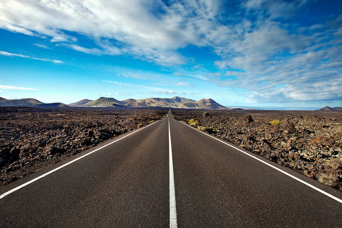 Street through volcanic landscape, Timanfaya National Park, Lanzarote, Canary Islands, Spain, Europe