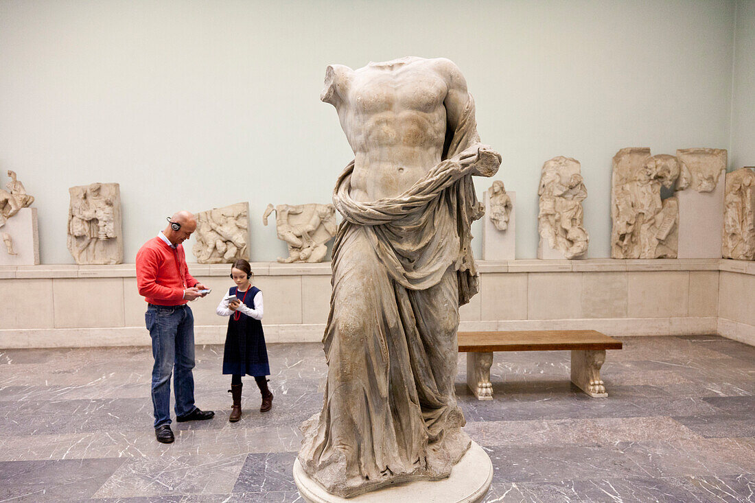 Father and daughter listening to the audio guide, Pergamon Museum, the Pergamon temple, Antiquities, Museum Island, Berlin State Museums, Prussian Cultural Heritage Foundation, Berlin, Germany