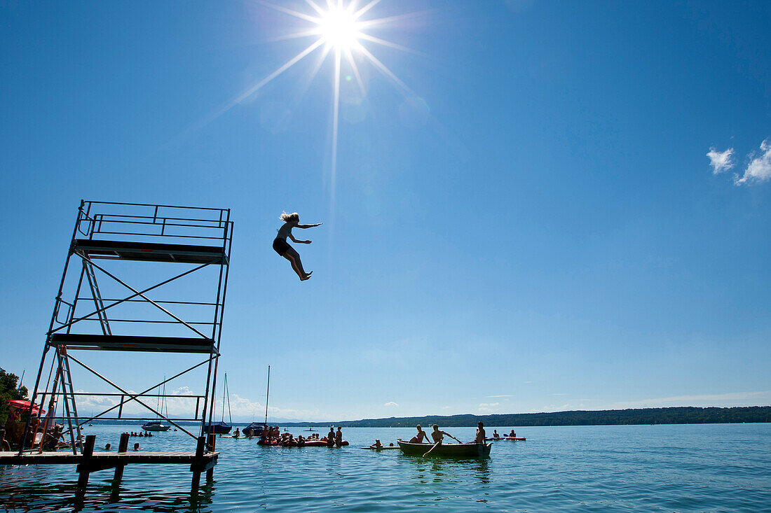 Child jumping into Lake Starnberg, Upper Bavaria, Germany, Europe