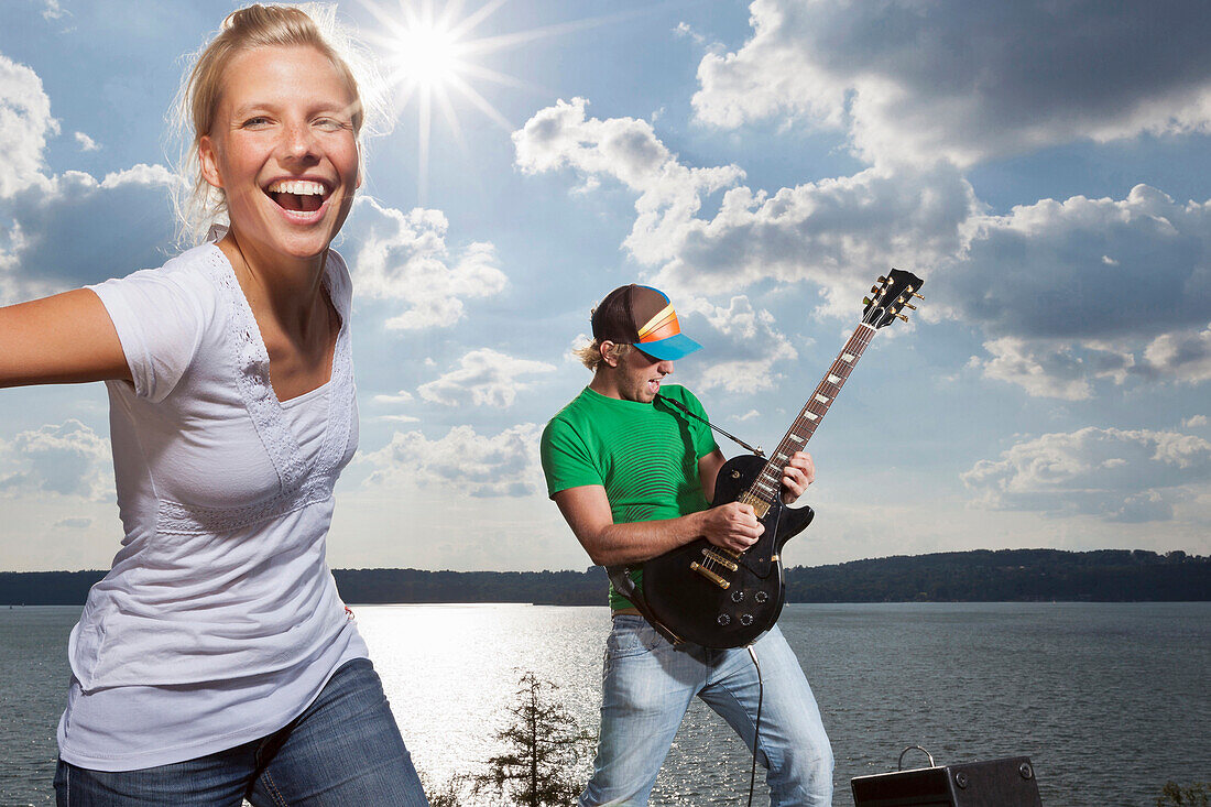 Girl and guitarist above Lake Starnberg, Upper Bavaria, Germany