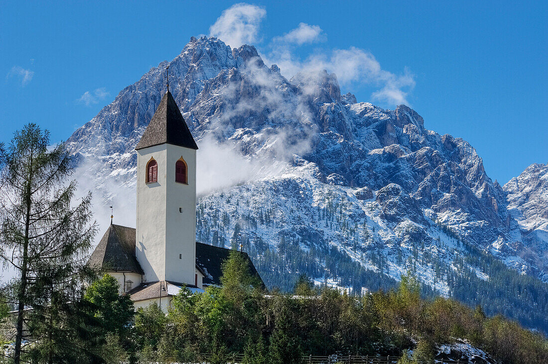 View of church with Dreischusterspitze, Innichen, Dolomites, South Tyrol, Italy, Europe