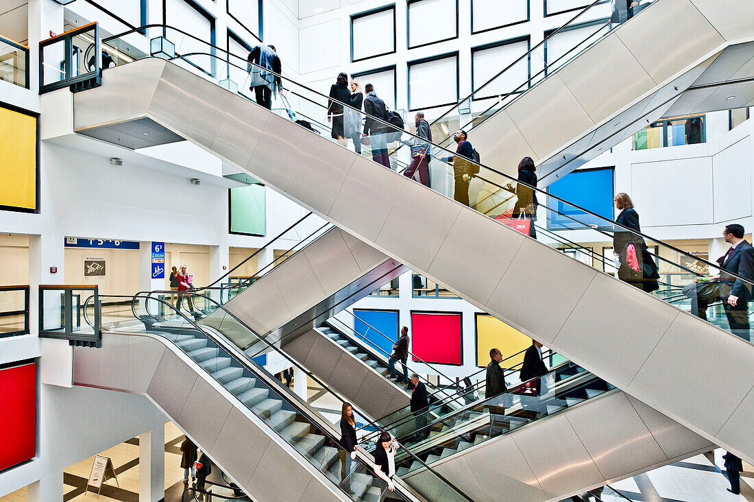 People, business people on escalators, Berlin Exhibition, Berlin, Germany