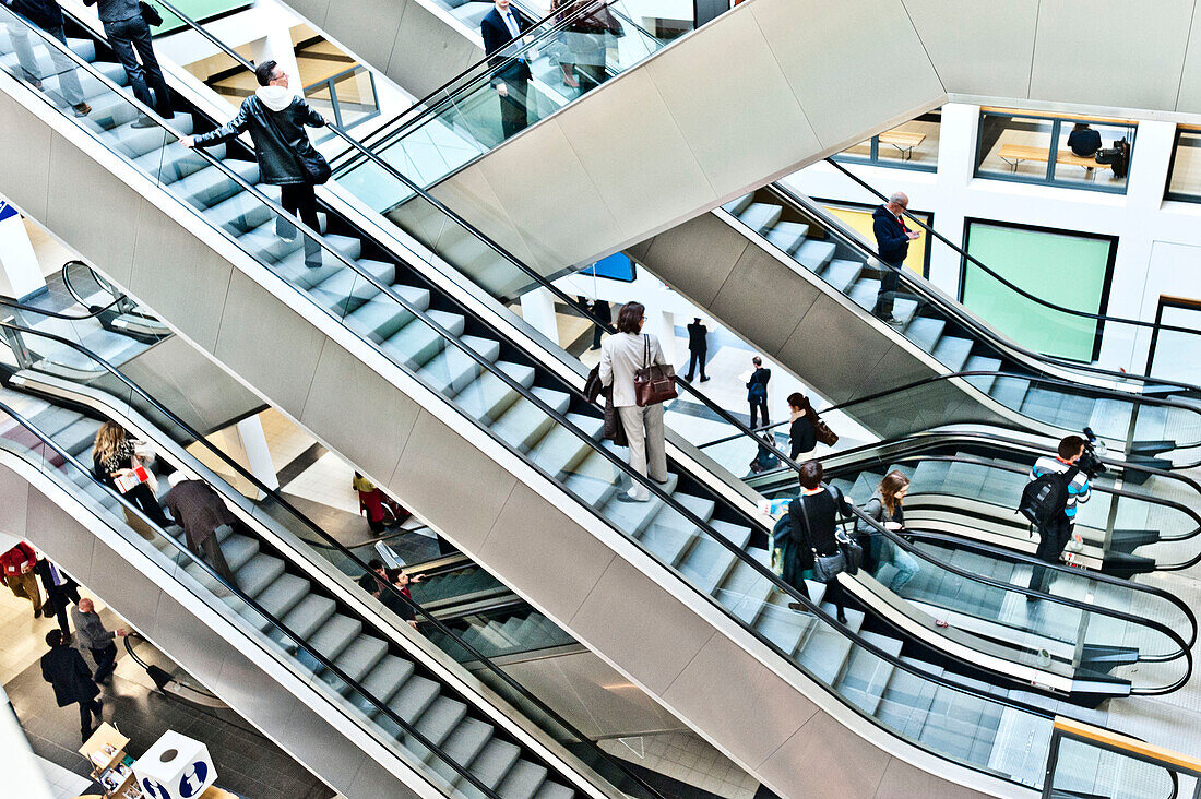 People, business people on escalators, Berlin Exhibition, Berlin, Germany