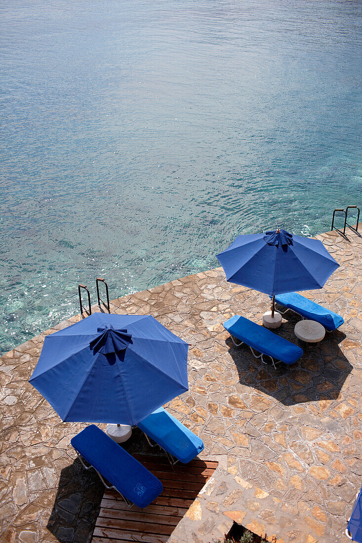 Sunshades and deck chairs at the seasite, Elounda, Agios Nikolaos, Crete, Greece