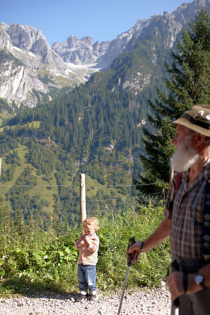 Child and mountain guide on a hiking path in the mountains, Gossensass, Brenner, South Tyrol, Trentino-Alto Adige/Suedtirol, Italy