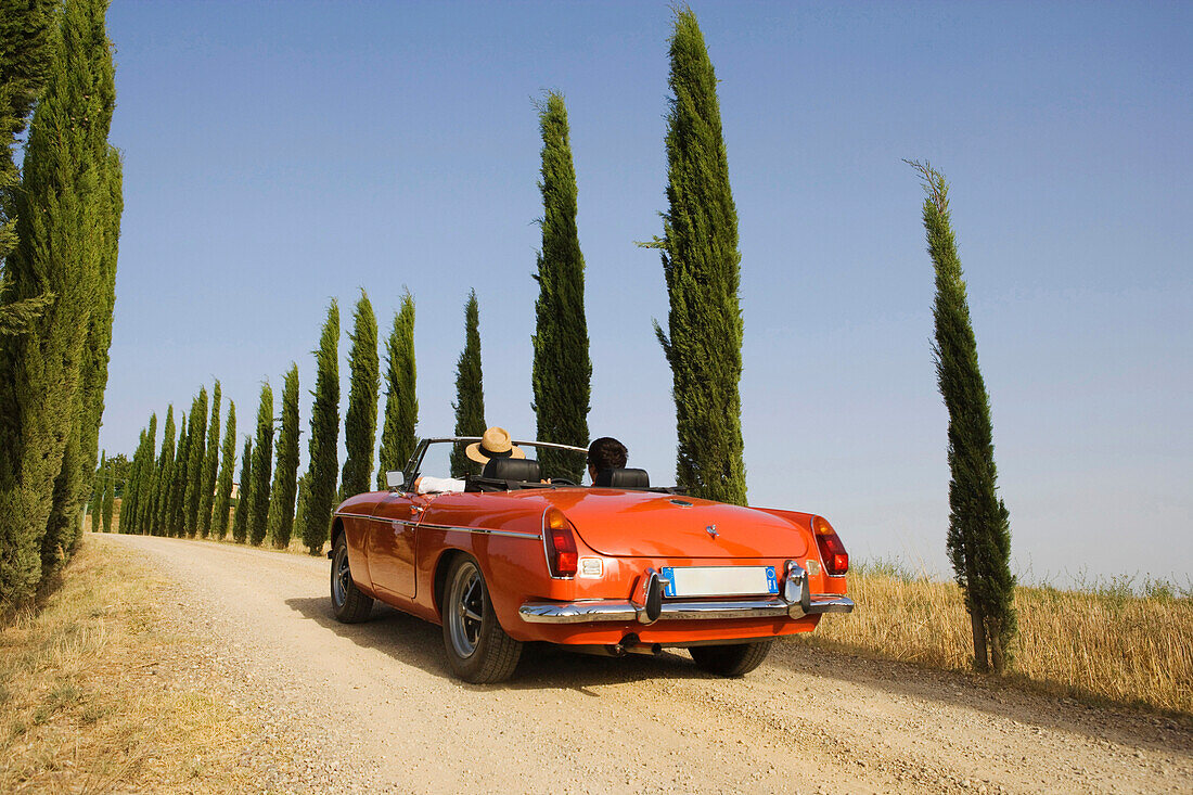 Vintage car on a country road at the Montalcino region, Tuscany, Italy, Europe