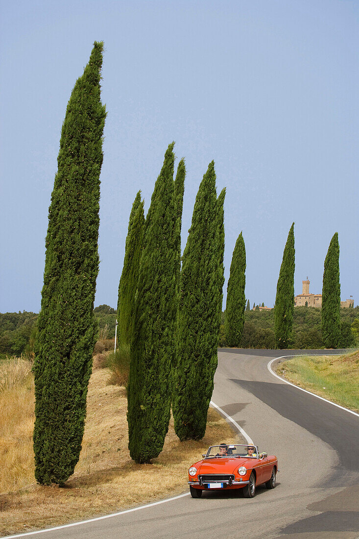 Vintage car on a country road at the Montalcino region, Tuscany, Italy, Europe