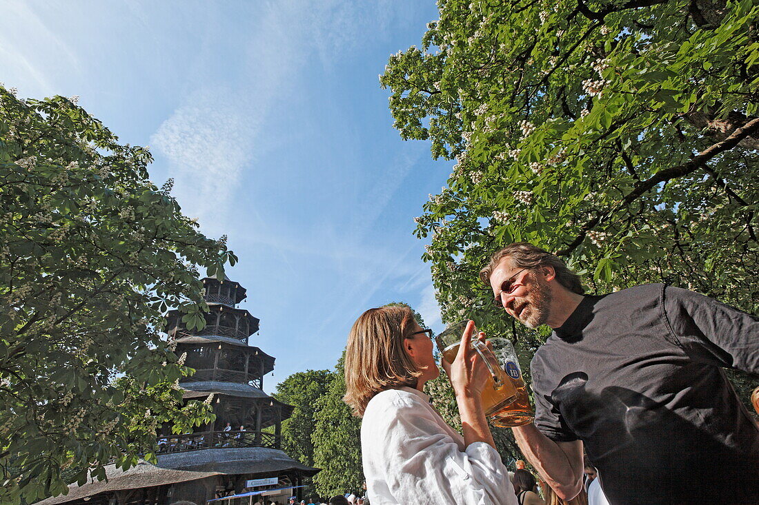 People enjoying a sunny day at the Chinesischer Turm beer garden, Englischer Garten, Munich, Upper Bavaria, Bavaria, Germany, Europe