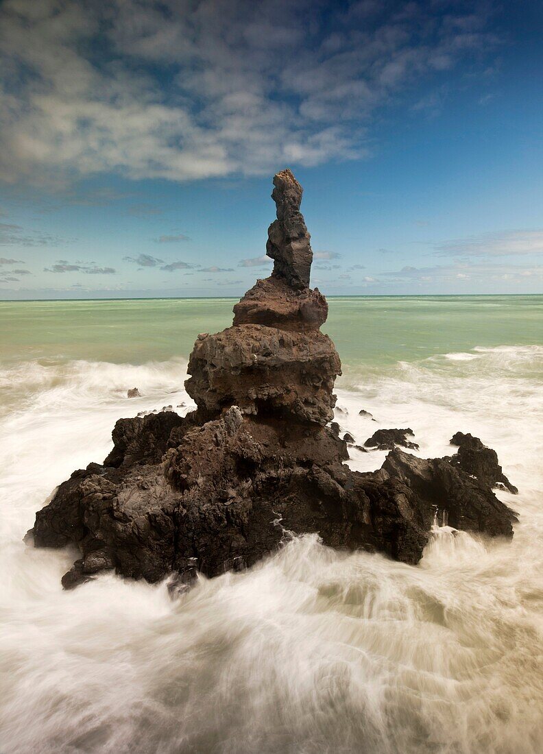 Sea stack off Tumbledown Bay, southern bays of Banks Peninsula, Canterbury, New Zealand.