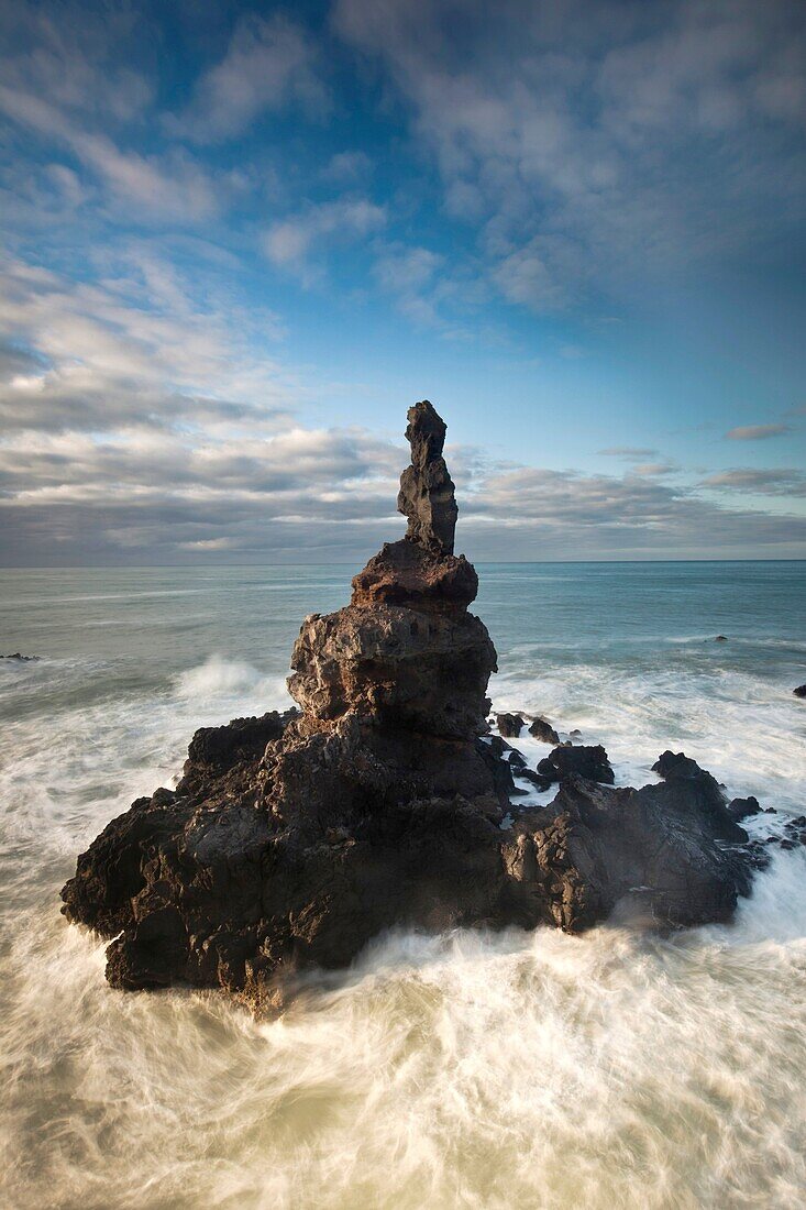 Sea stack off Tumbledown Bay, dawn, southern bays of Banks Peninsula, Canterbury, New Zealand.