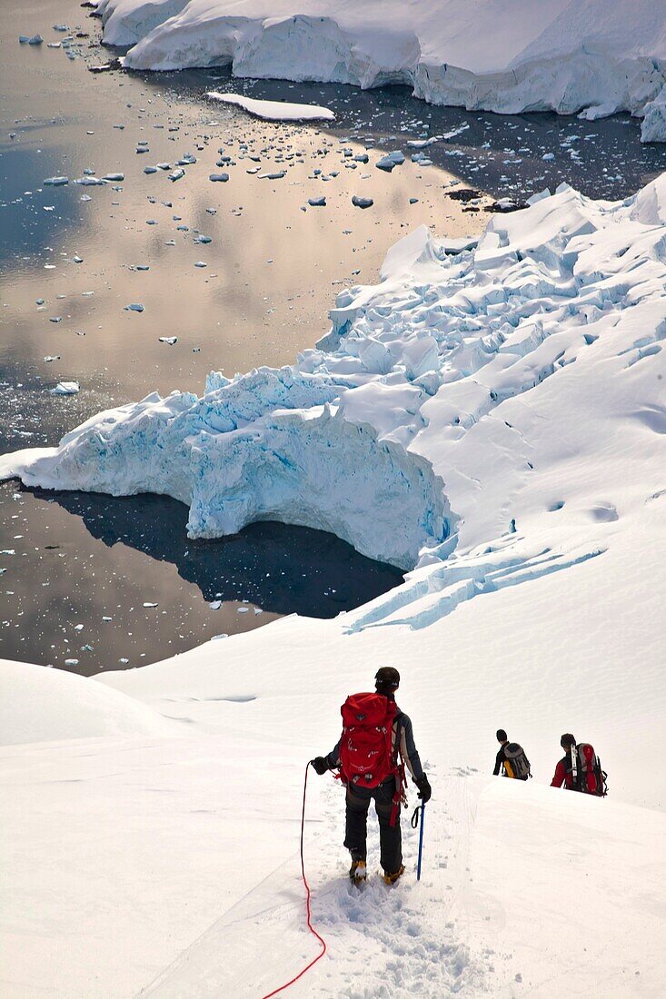 Climbers descend Peon Peak, Ronge Island, Antarctic Peninsula.