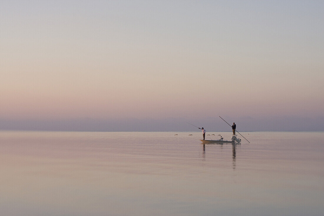 Two Men Fishing in Boat on Calm Water, Florida Keys, USA