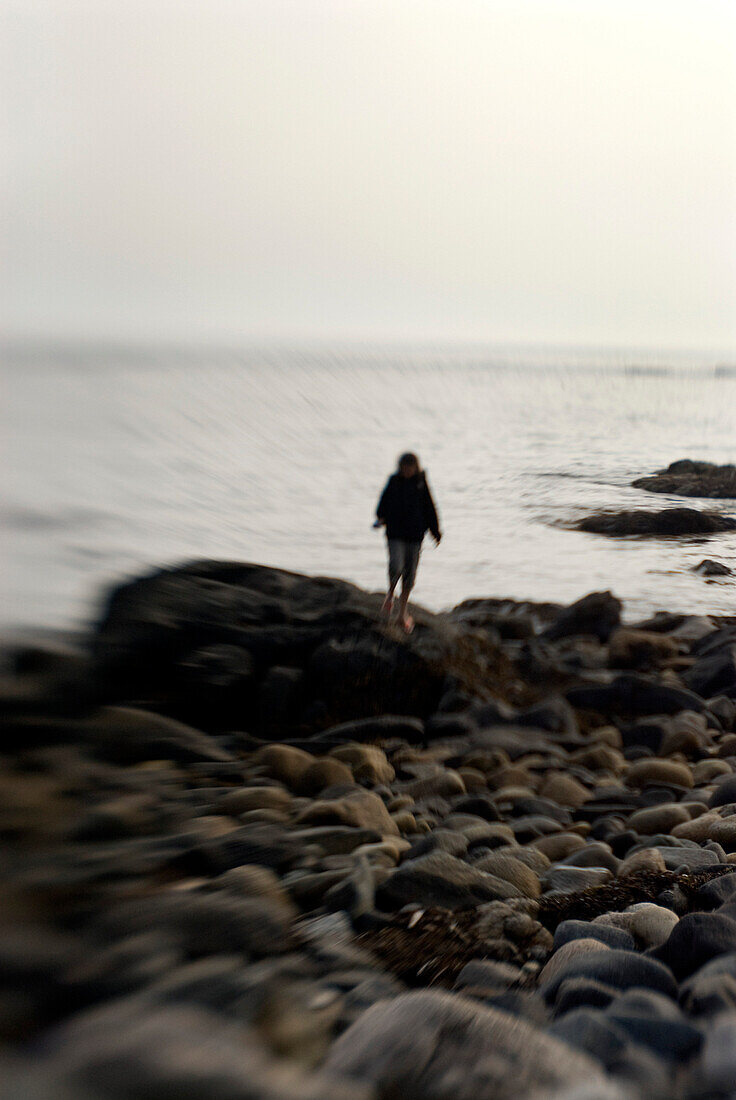 Young Woman on Rocky Shore