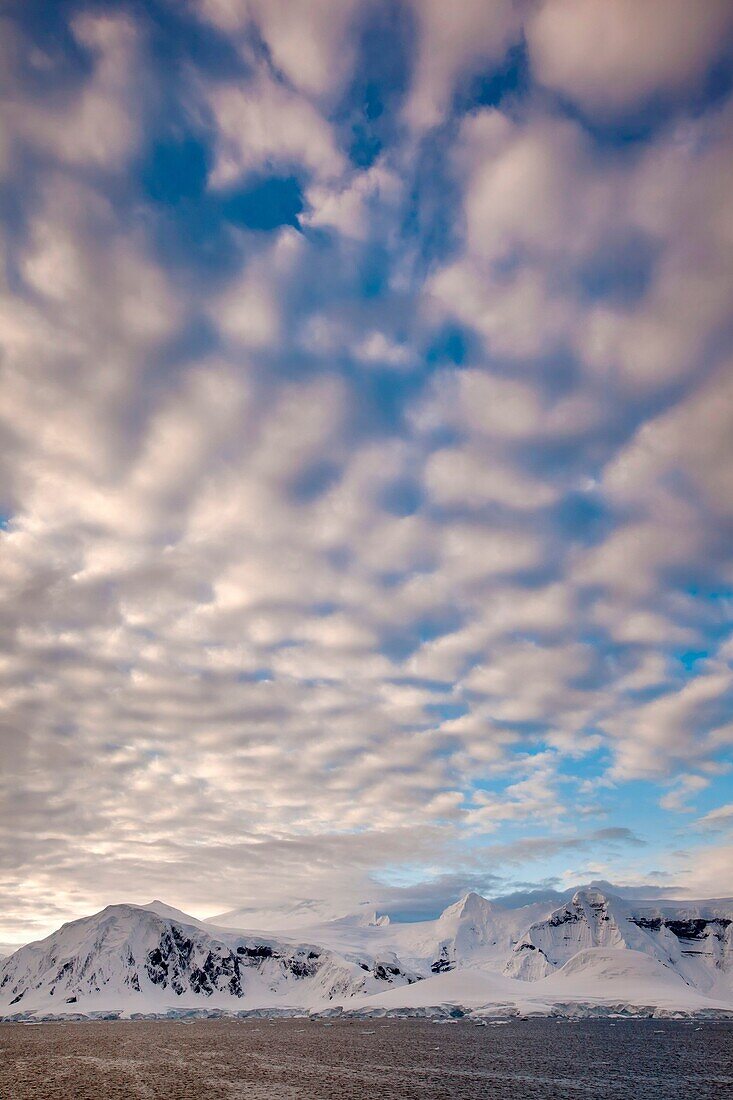 High cloud over peaks in Neumeyer Channel, Antarctic Peninsula.