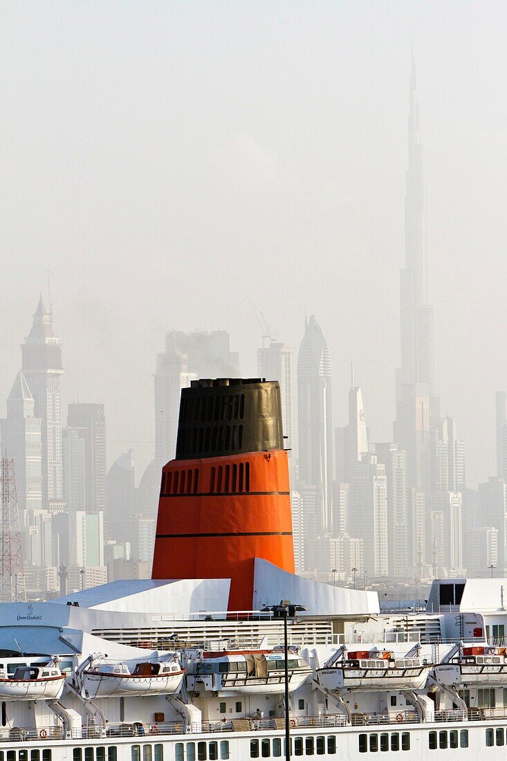 The Dubai city skyline and the Queen Elizabeth II ocean liner in Dubai harbour, UAE.