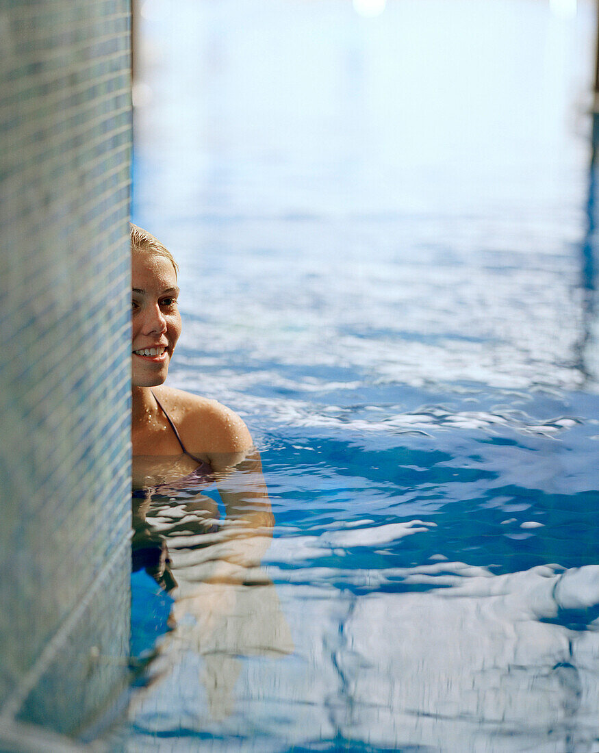 Woman in a swimming pool of a spa resort, Travemuende, Luebeck, Schleswig-Holstein, Germany