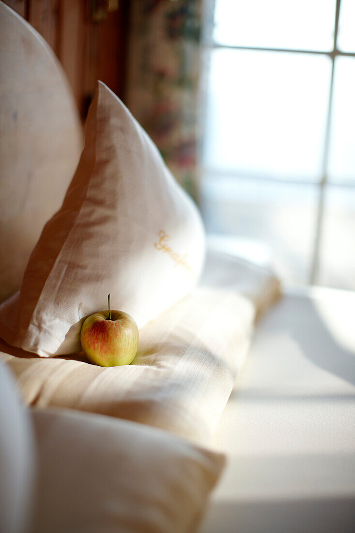 Apple on a cushion in a nature hotel, Am Hochpillberg, Schwaz, Tyrol, Austria