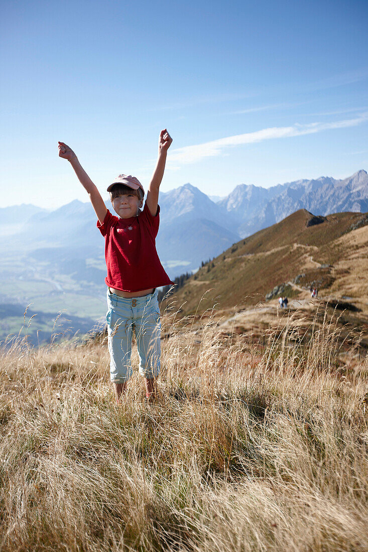 Girl standing on meadow, Am Hochpillberg, Schwaz, Tyrol, Austria