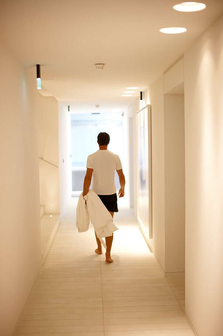 Man walking along a hallway in spa area of a hotel, Ramatuelle, Provence-Alpes-Cote d'zur, France