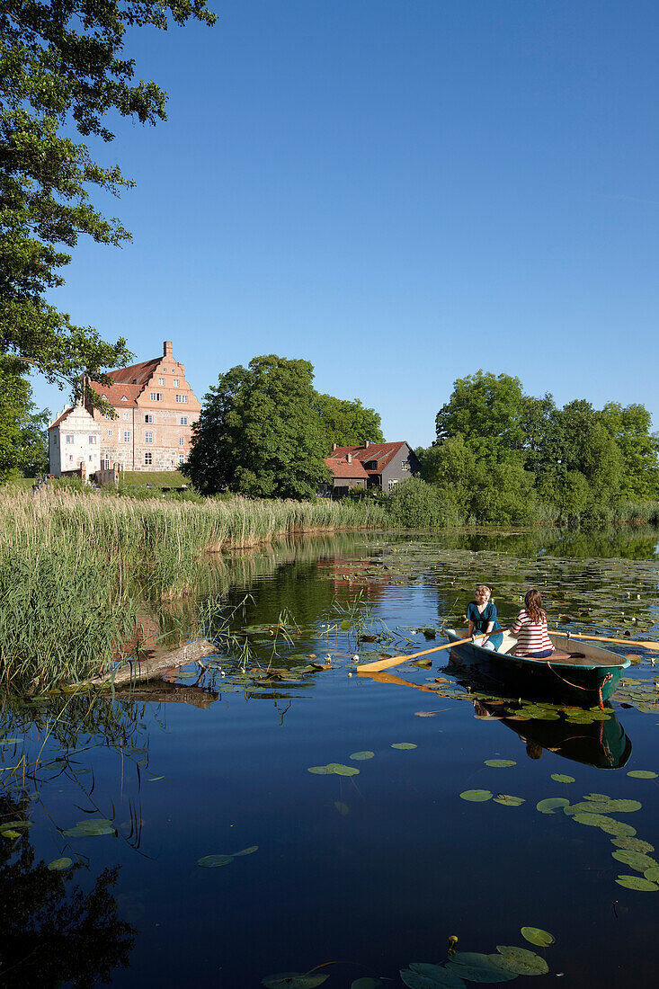 Two women in a rowing boat on lake Ulrichshusen, Ulrichshusen castle, Mecklenburg-West Pomerania, Germany