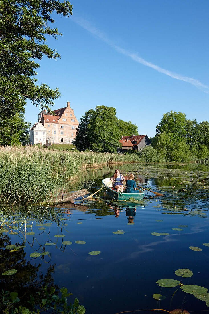 Two women in a rowing boat on lake Ulrichshusen, Ulrichshusen castle, Mecklenburg-West Pomerania, Germany