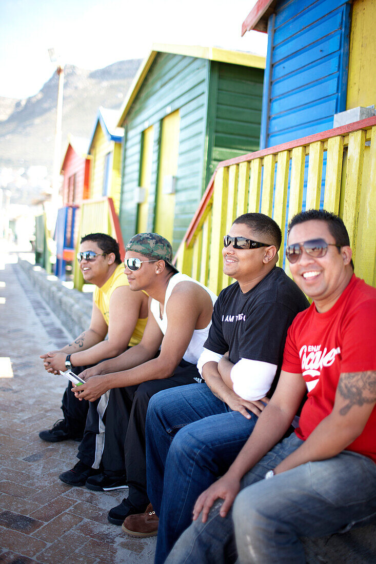 Men sitting in front of Edwardian Beach Houses, Muizenberg, Peninsula, Cape Town, South Africa, Africa