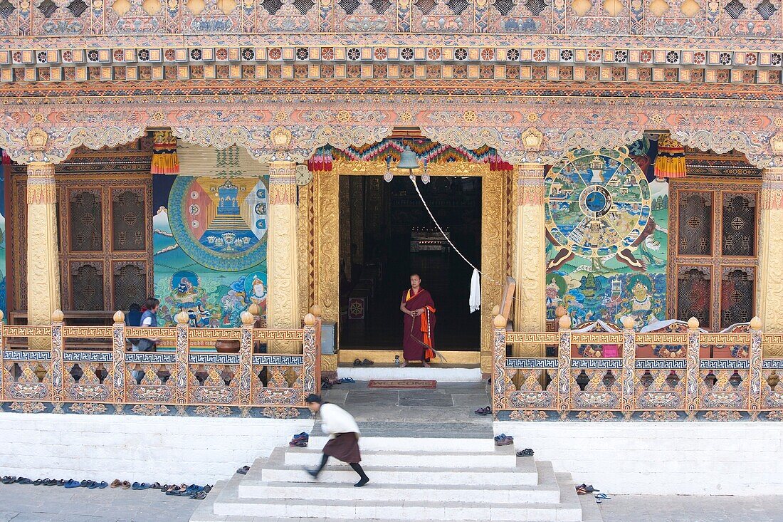 Monks getting out froms a temple after meditating