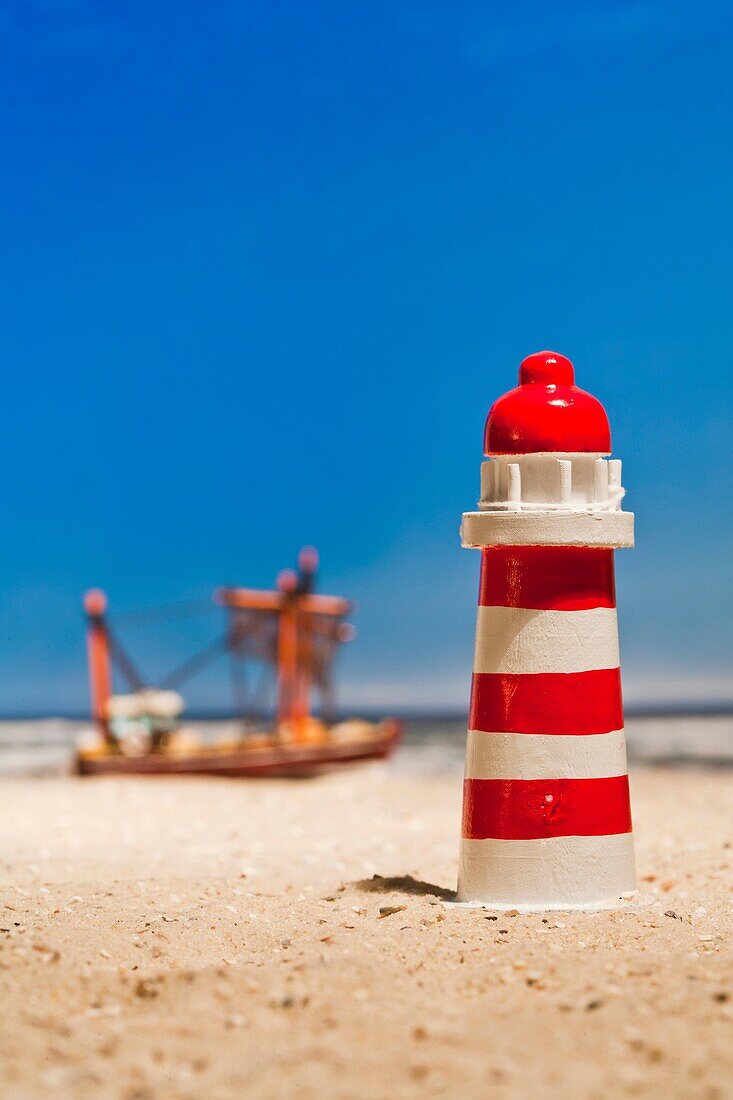Still life of a miniature lighthouse and fishing boat