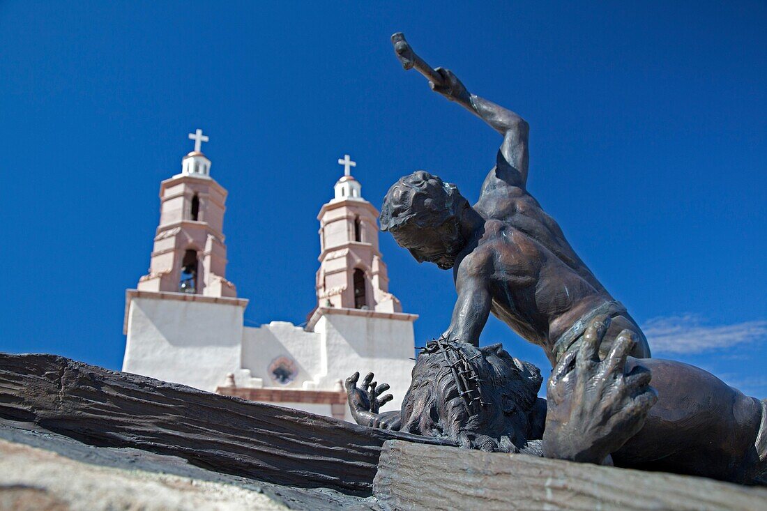 San Luis, Colorado - The Shrine of the Stations of the Cross is on a hill above town  The sculptures were created by artist Huberto Maestas  In the background is the Chapel of All Saints