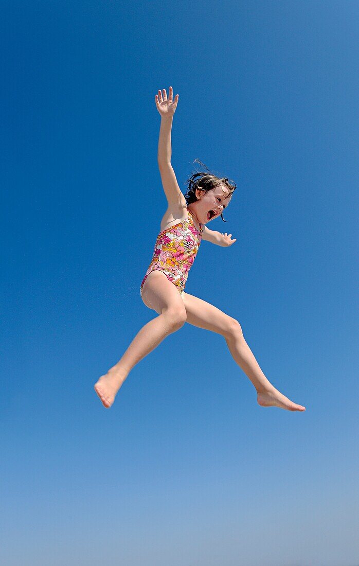 Jouful girl jumping, Ocean City, New Jersey, USA