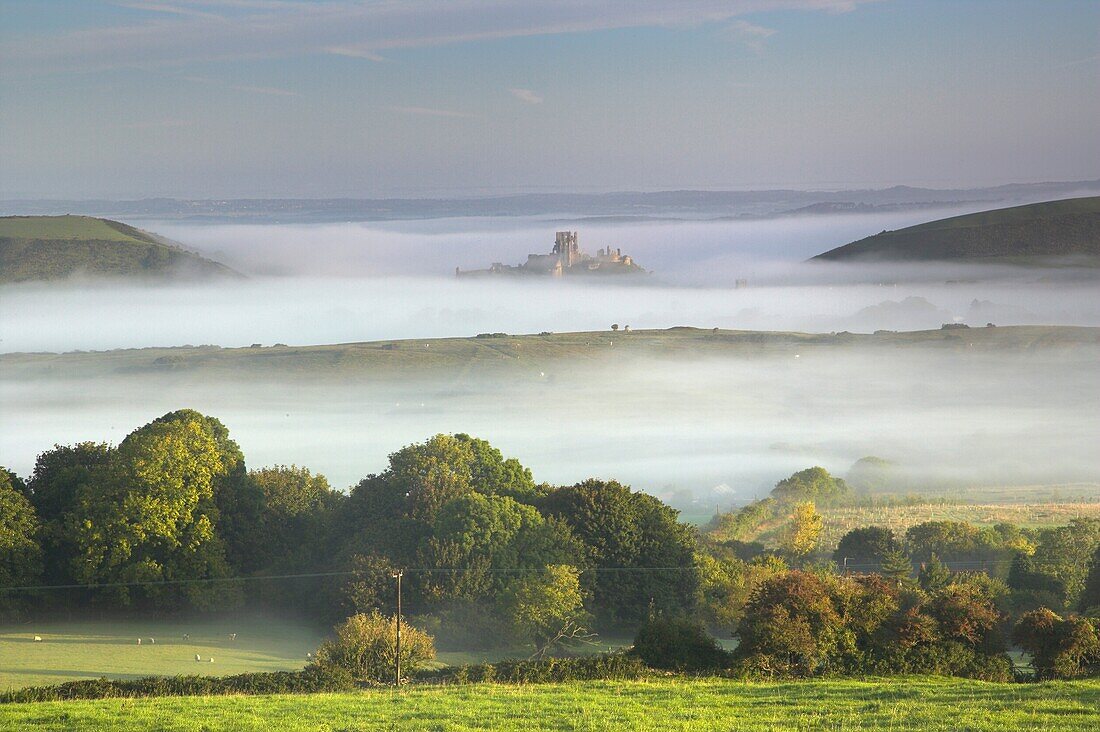 Corfe Castle viewed from Kingstone rising out of the mist Purbeck Dorset