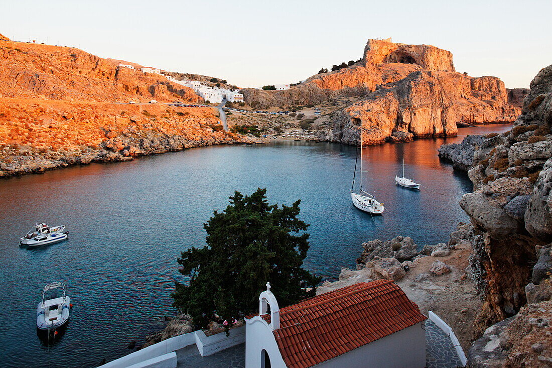 Agios Pavlos Bay and the ruins of the acropolis, Lindos, Rhodes, Dodecanese Islands, Greece, Europe