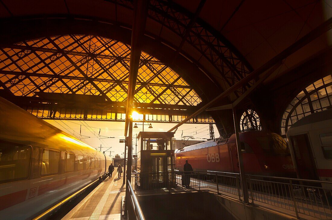 Passengers arrive at the train station at Dresden after sunrise, Saxony, Germany
