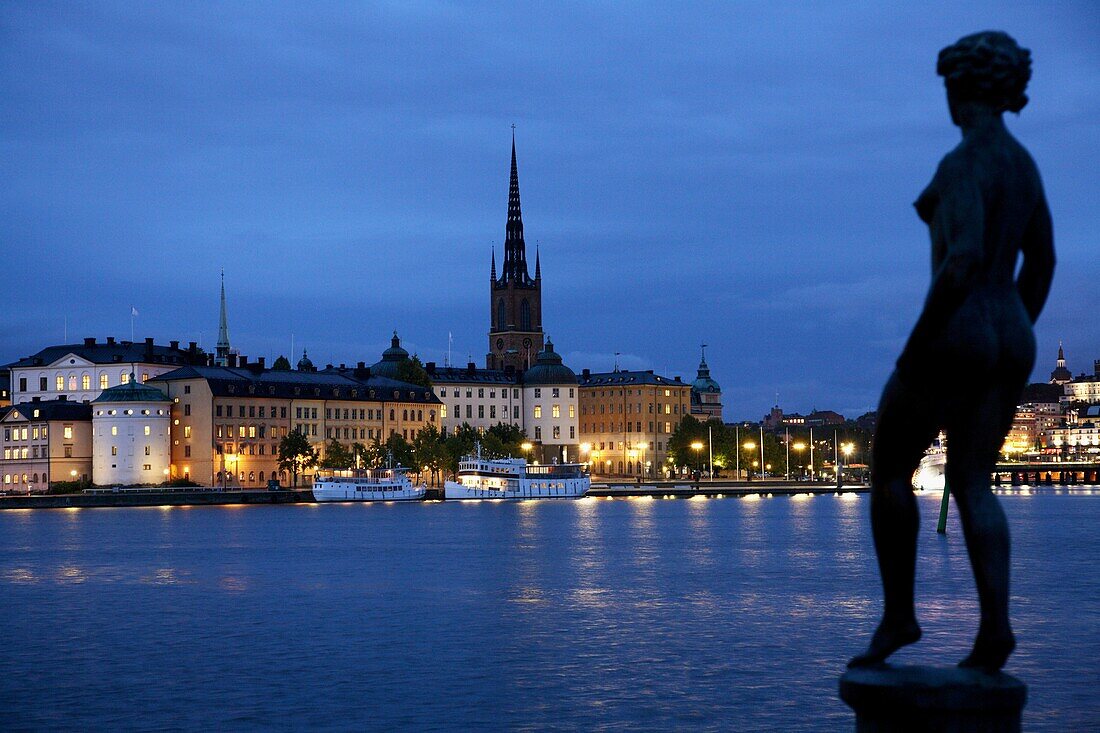 Night view of Riddarholmen Island with the black spire of Riddarholmskyrkan (Riddarholmen Church) in background, Stockholm, Sweden