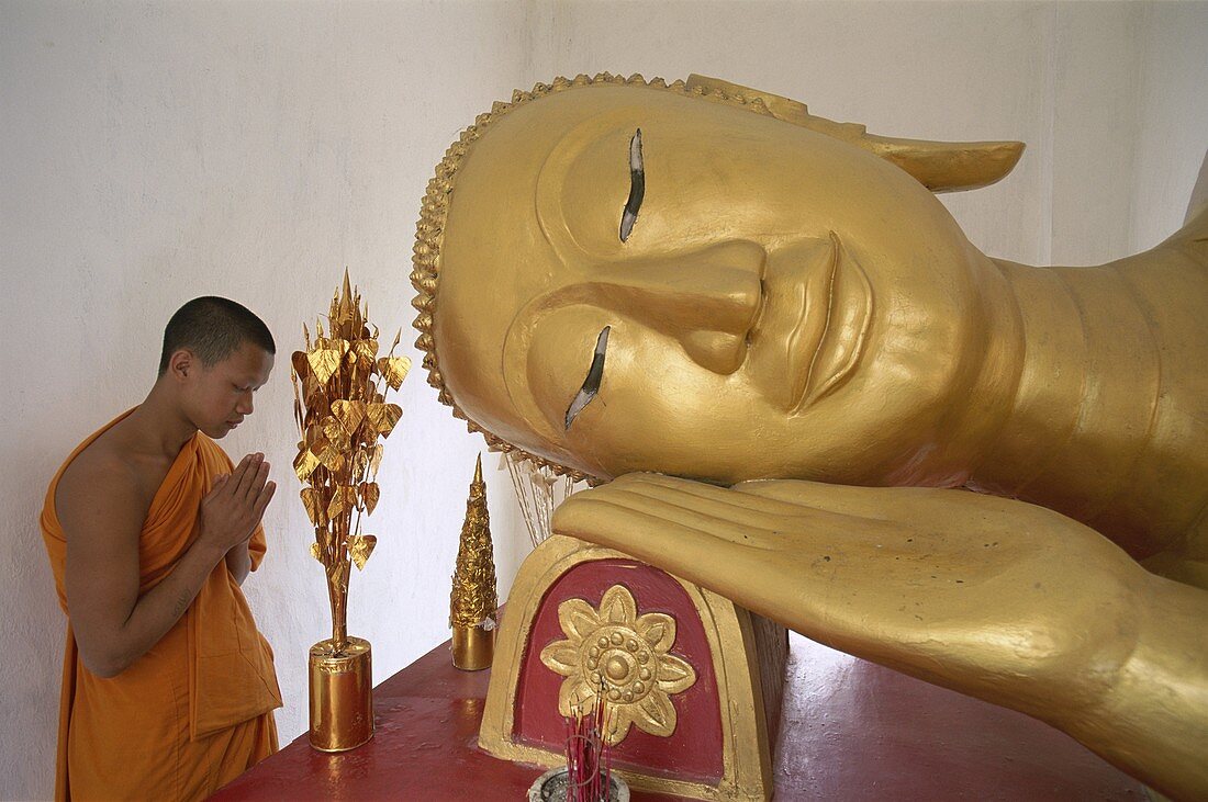 Laos, Luang Prabang, Novice Monk Preying, Reclining. Baat, Heritage, Holiday, Landmark, Laos, Asia, Luang prabang, Monk, Novice, Pha, Preying, Reclining buddha, Tai, Tourism, Travel