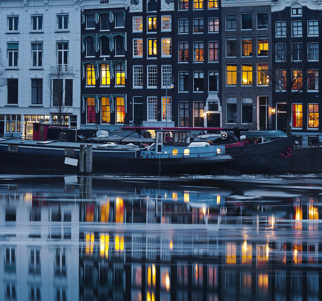 Ice drift on river Amstel at dusk, Amsterdam, North Holland, Netherlands