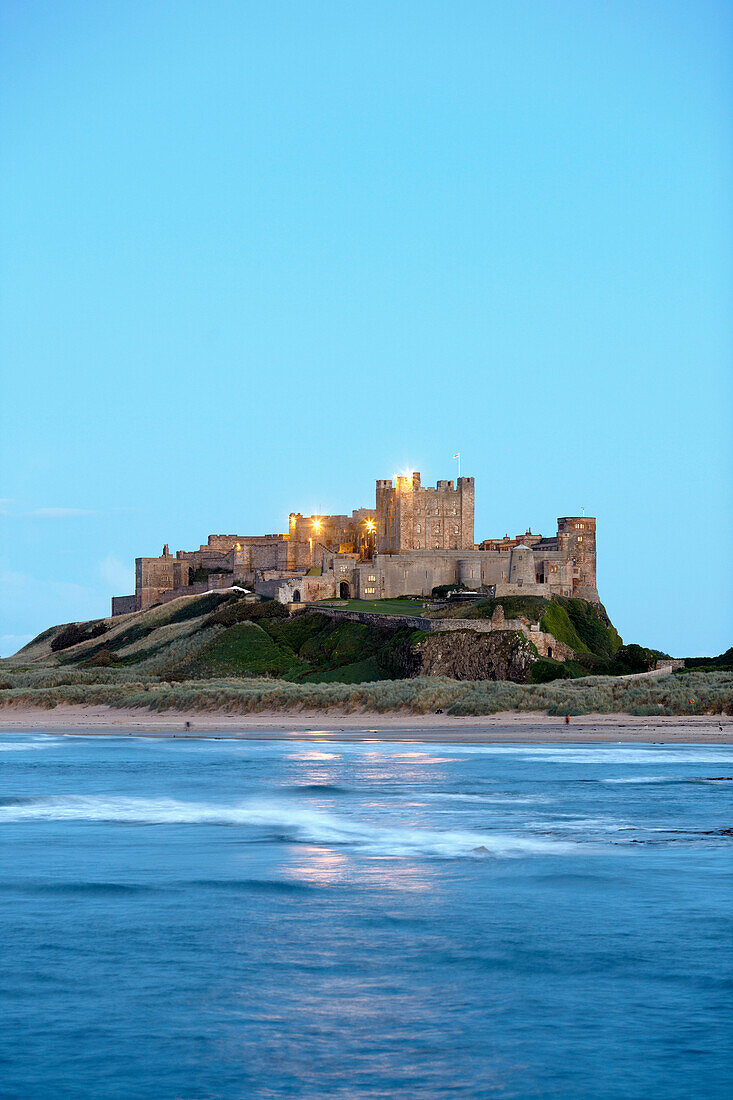 Coastline below Bamburgh Castle in the evening, Bamburgh, Northumberland, England, Great Britain, Europe