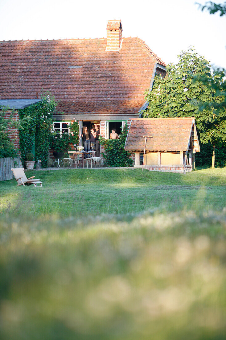 Family standing in a house entrance, Klein Thurow, Roggendorf, Mecklenburg-Western Pomerania, Germany